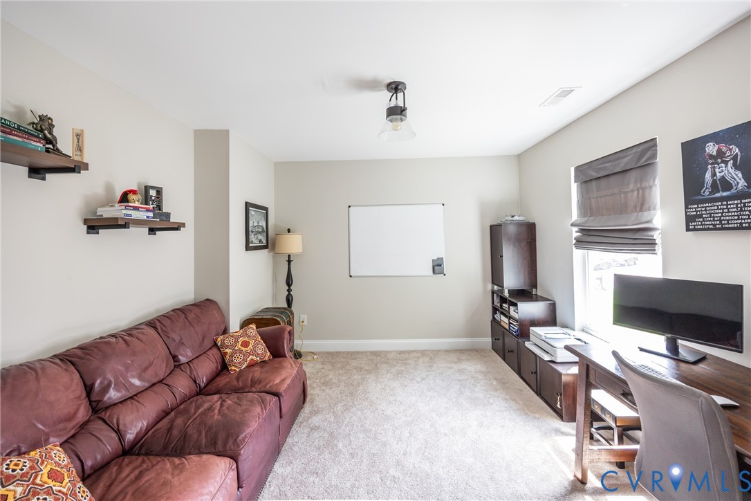 15206 Blackrail Road Chesterfield, VA 23832 - Photo 30 of 50 a living room with furniture and a flat screen tv
