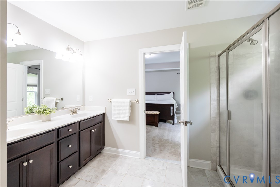15206 Blackrail Road Chesterfield, VA 23832 - Photo 31 of 50 a spacious bathroom with a double vanity sink and a mirror