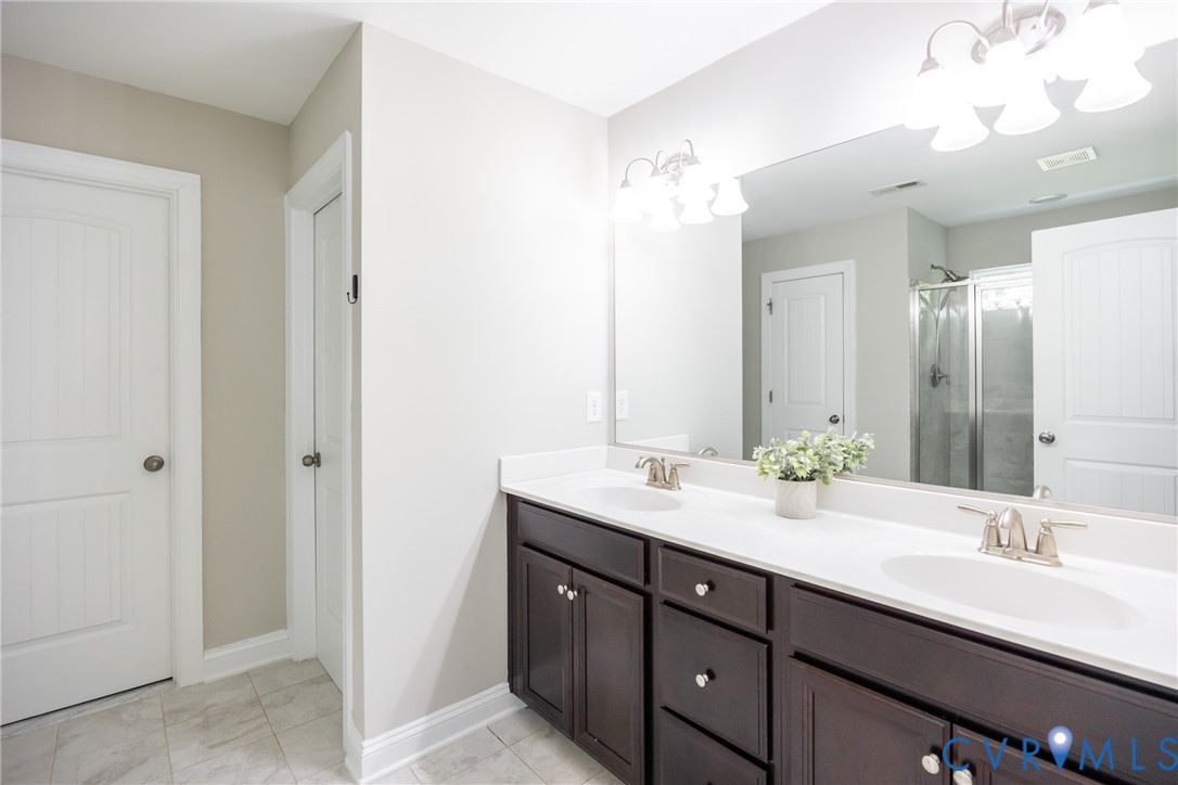 15206 Blackrail Road Chesterfield, VA 23832 - Photo 33 of 50 a bathroom with a double vanity sink and a mirror