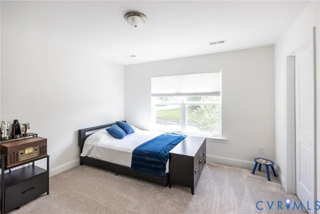 a living room with a bed and a window