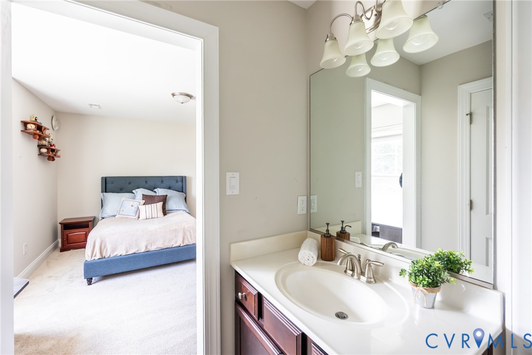 15206 Blackrail Road Chesterfield, VA 23832 - Photo 37 of 50 a bedroom with a bed chandelier and couch