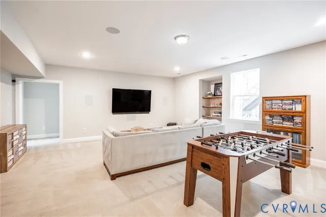 a living room with a flat screen tv and a rug