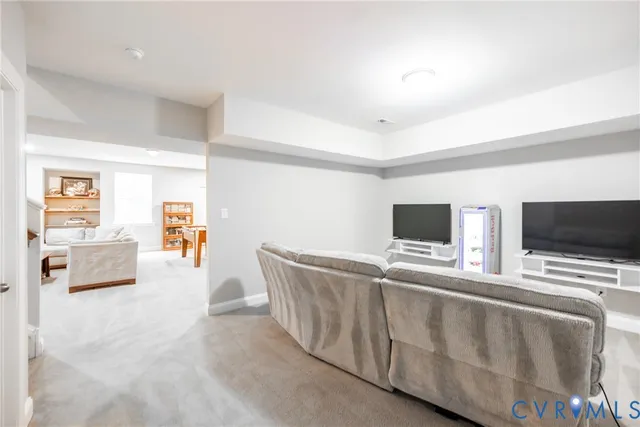 a living room with furniture cabinets and a window