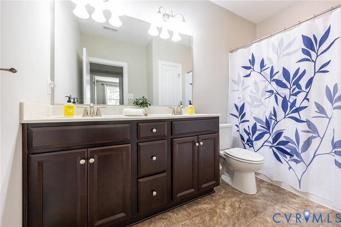 15206 Blackrail Road Chesterfield, VA 23832 - Photo 46 of 50 a bathroom with a sink and a mirror