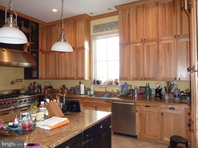 1003 Hiatt Road Winchester, VA 22603 - Photo 14 of 28 a kitchen with sink refrigerator and cabinets