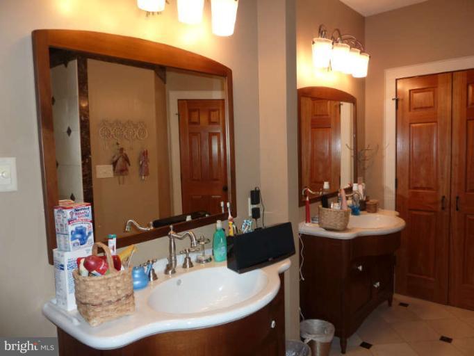 1003 Hiatt Road Winchester, VA 22603 - Photo 17 of 28 a bathroom with a sink and a mirror