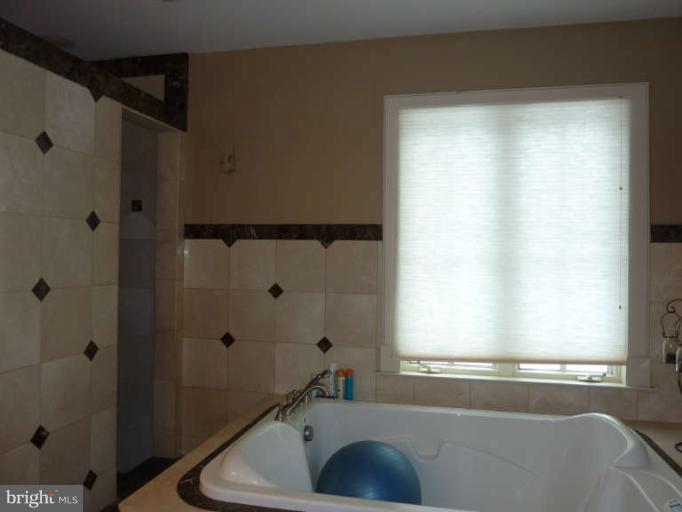 1003 Hiatt Road Winchester, VA 22603 - Photo 18 of 28 a bathroom with a sink and a window
