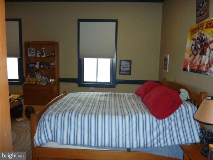1003 Hiatt Road Winchester, VA 22603 - Photo 23 of 28 a bedroom with a bed and painting on the wall