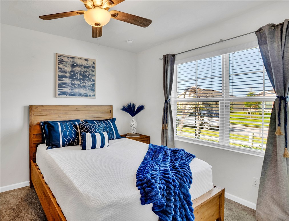 3453 Trinity Circle Fort Pierce, FL 34945 - Photo 18 of 36 a bedroom with a bed and window