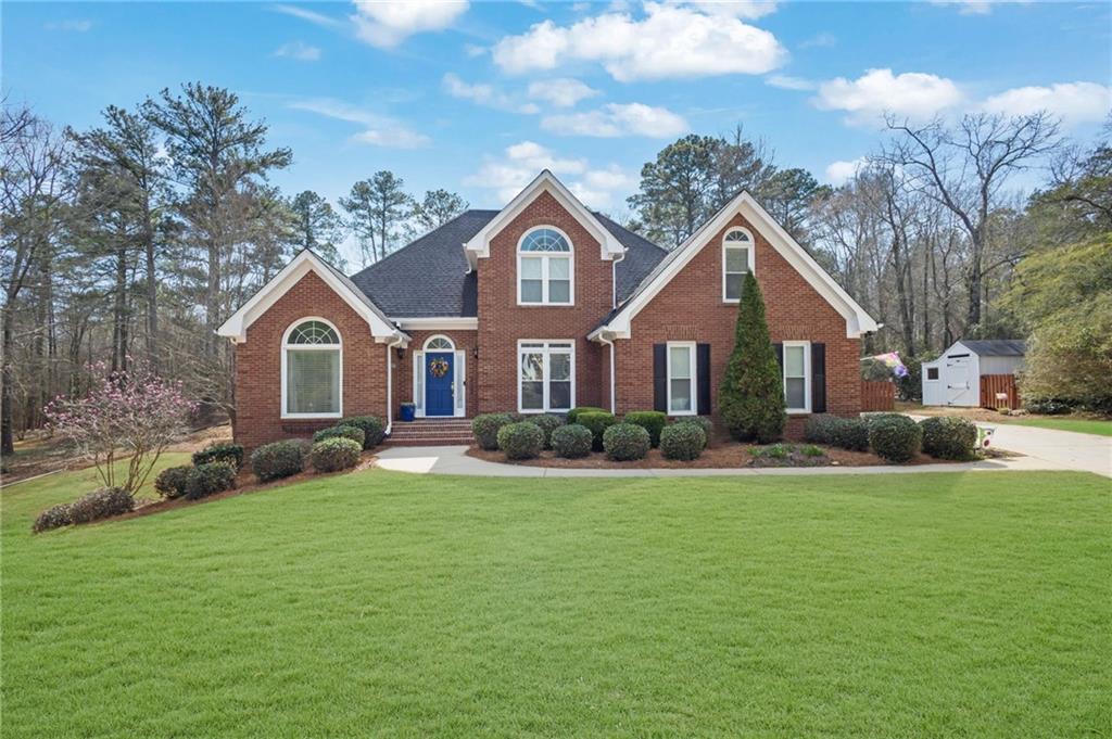 2609 Fireside Trail Southwest Conyers, GA 30094 - Photo 1 of 1 a front view of a house with garden