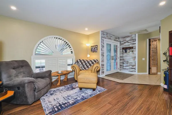 a living room with furniture and a wooden floor