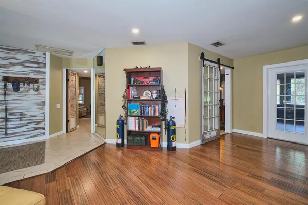 a living room with furniture and wooden floor