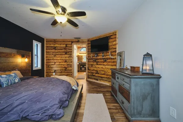 a bedroom with a bed and a chandelier