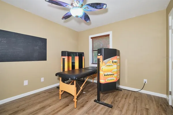 a view of a house with a yard covered in snow