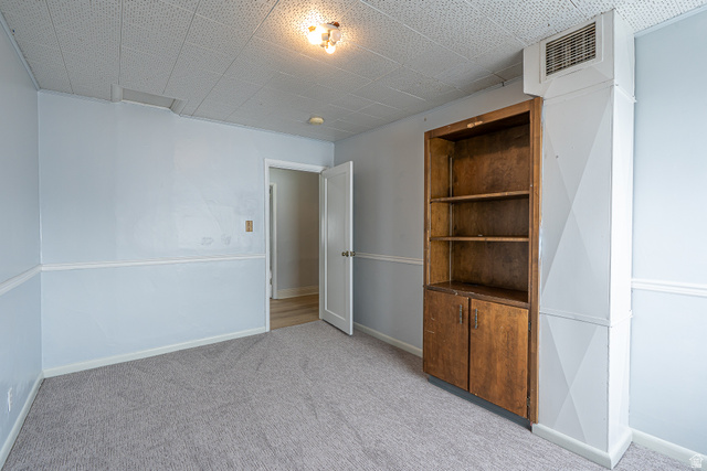33 North 200 East Logan, UT 84321 - Photo 29 of 54 Empty room with light carpet and baseboards