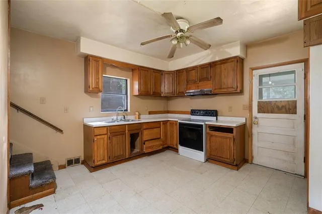 a kitchen with stainless steel appliances a stove and a refrigerator