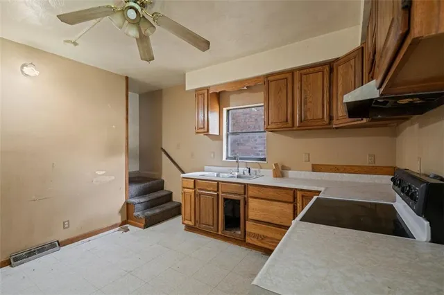 a kitchen with stainless steel appliances granite countertop a stove and a sink