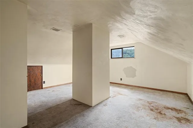 a view of a house with a small yard and furniture