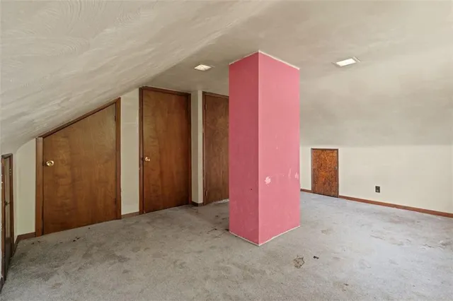 an aerial view of residential houses with outdoor space and parking