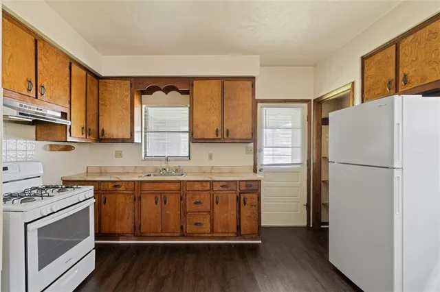 a kitchen with a sink stove and refrigerator