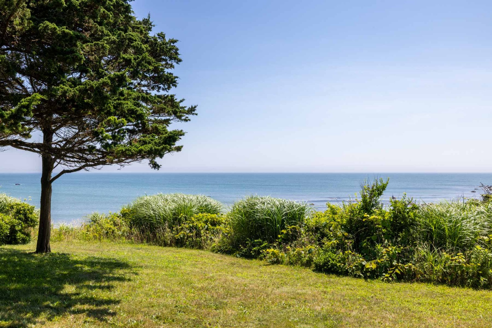 64 Squibnocket Farm Road Chilmark, MA 02535 - Photo 14 of 43 a view of a lake with a yard
