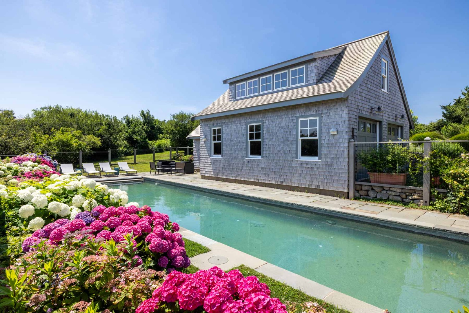 64 Squibnocket Farm Road Chilmark, MA 02535 - Photo 15 of 43 a front view of a house with swimming pool and yard