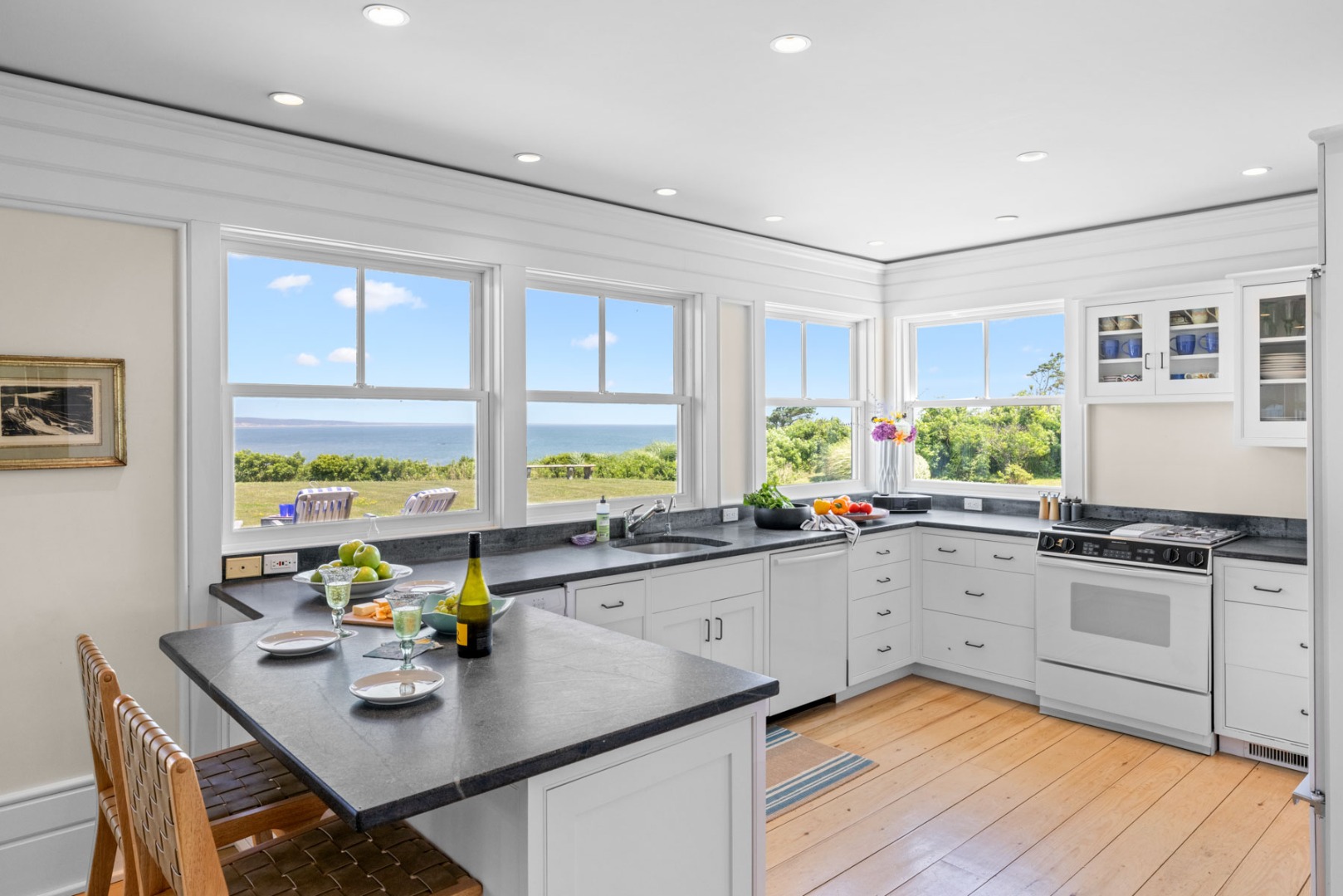 64 Squibnocket Farm Road Chilmark, MA 02535 - Photo 24 of 43 a kitchen with a sink stove and cabinets