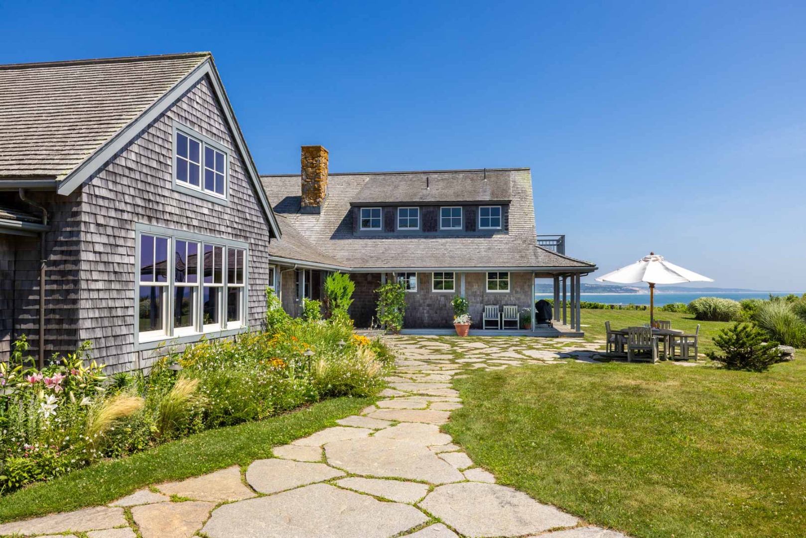 64 Squibnocket Farm Road Chilmark, MA 02535 - Photo 4 of 43 a front view of house with yard and trees around