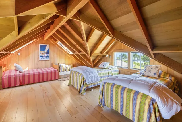 a view of a balcony with two couches and chairs with wooden floor