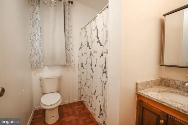 a bathroom with a granite countertop toilet sink and shower