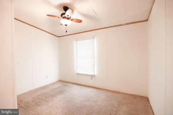 a view of a room with a window and a ceiling fan