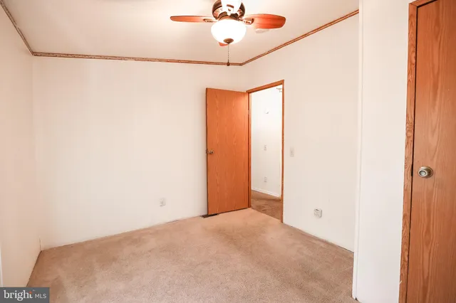 a view of a room with cabinet and a ceiling fan