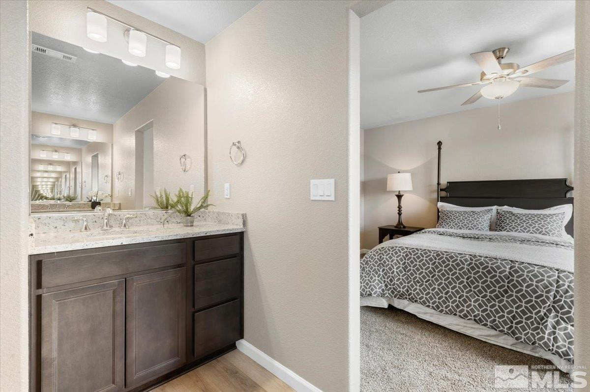 1164 Arrastra Road, Unit LOT 19 Reno, NV 89512 - Photo 20 of 34 a bedroom with a bed and a mirror