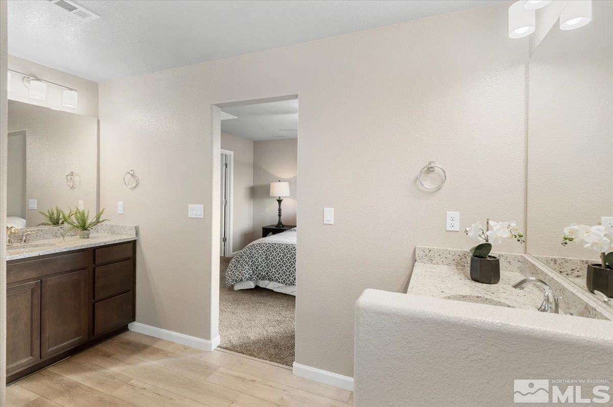 1164 Arrastra Road, Unit LOT 19 Reno, NV 89512 - Photo 22 of 34 a en suite bathroom with a double vanity sink and mirror