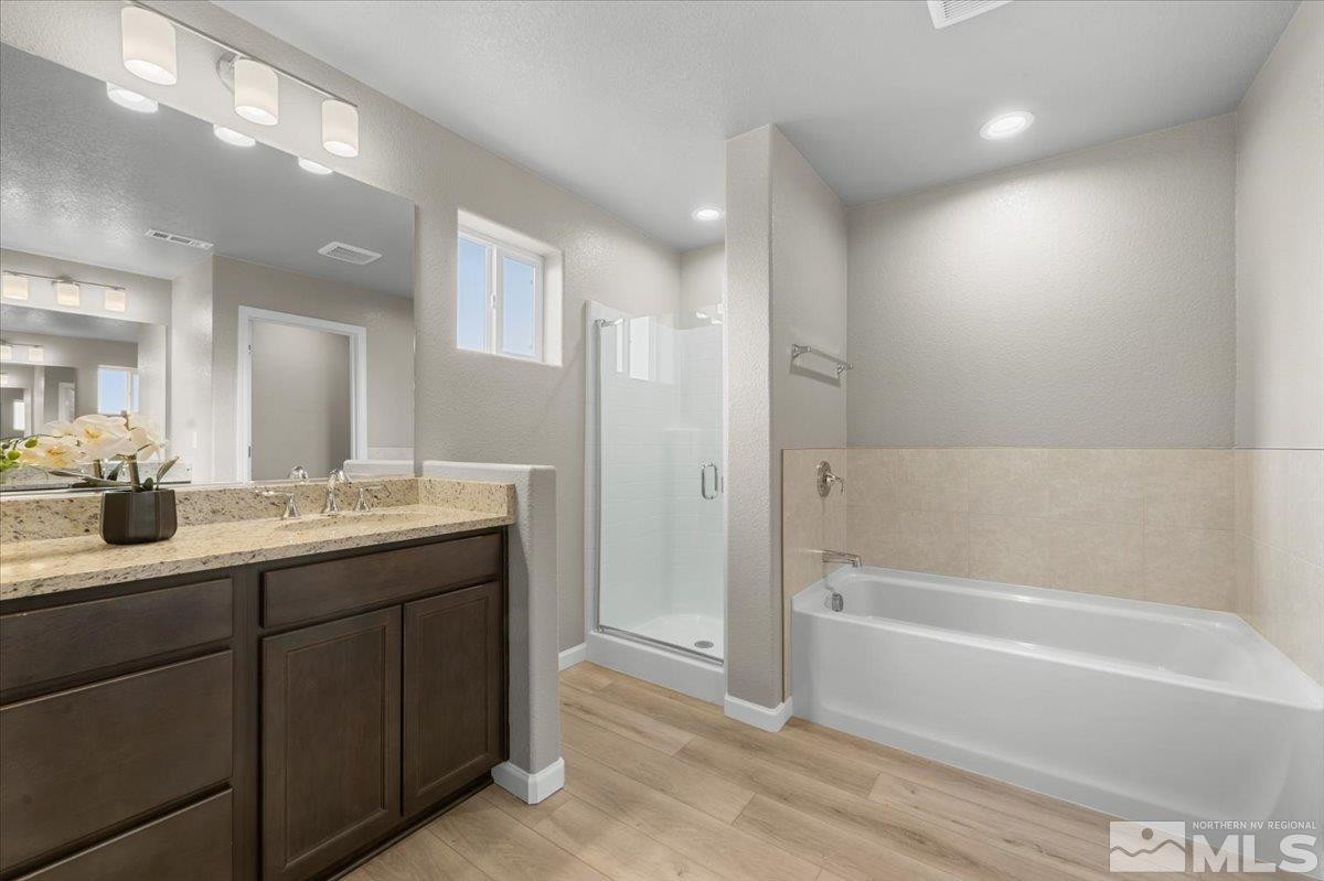 1164 Arrastra Road, Unit LOT 19 Reno, NV 89512 - Photo 25 of 34 a bathroom with a tub sink shower and a mirror