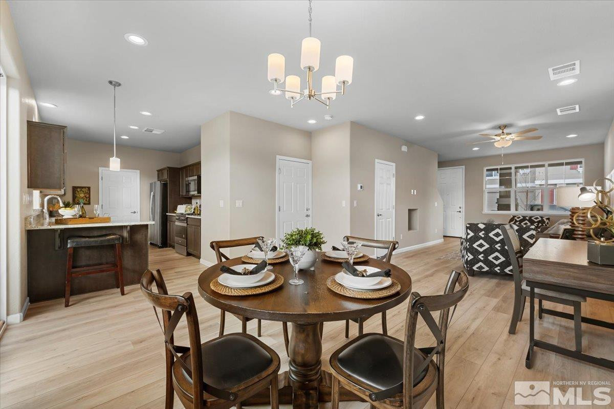 1164 Arrastra Road, Unit LOT 19 Reno, NV 89512 - Photo 8 of 34 a view of a dining room with furniture and wooden floor