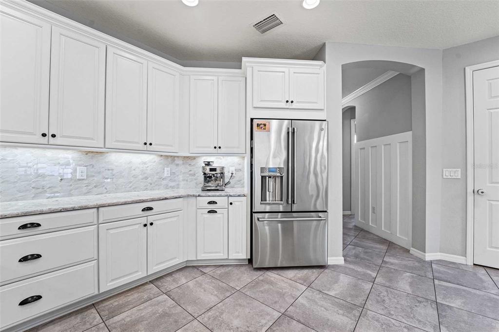 8903 Arabella Lane Seminole, FL 33777 - Photo 10 of 47 a kitchen with white cabinets and refrigerator