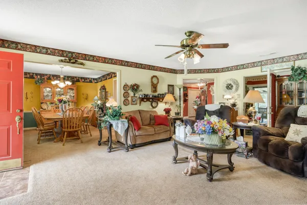 a living room with furniture and a chandelier