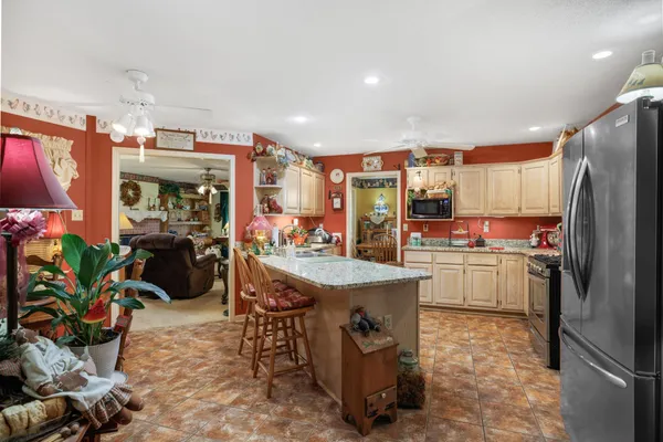 a kitchen with refrigerator and cabinets