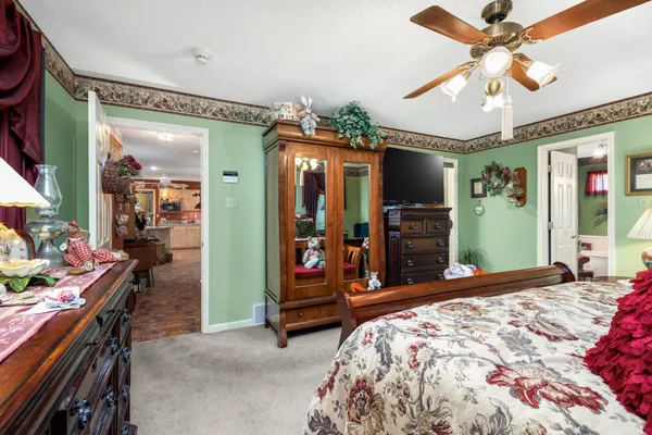 a bedroom with bed and a chandelier