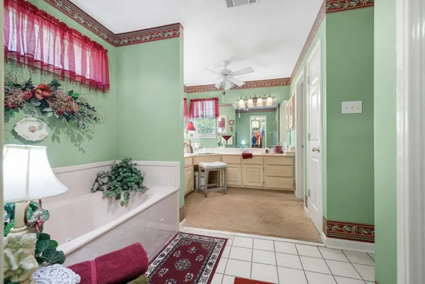 a bathroom with a sink mirror and vanity