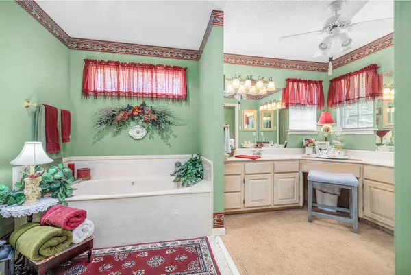 a bathroom with a bathtub a sink and a large mirror