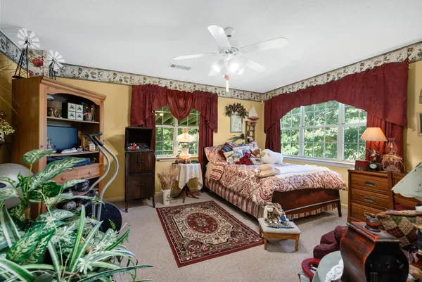 a bed room with furniture and a large window