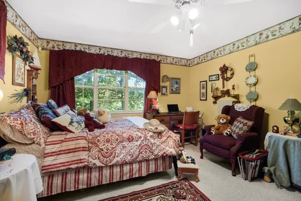 a bedroom with a bed couch and window