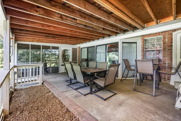 a view of a dining room with wooden floor and outdoor seating