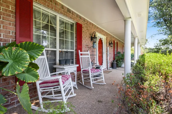 a couple of chairs sitting in front of a house