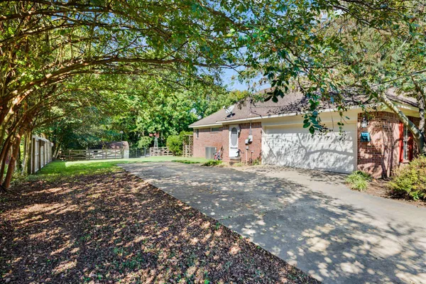 a view of a house with a tree in the background