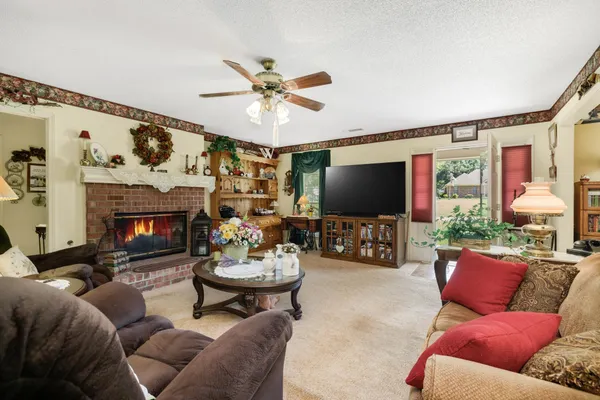 a living room with furniture a flat screen tv and a fireplace