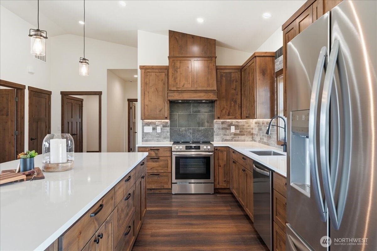 110 Slide View Lane Manson, WA 98831 - Photo 13 of 38 a large kitchen with stainless steel appliances a sink and a refrigerator