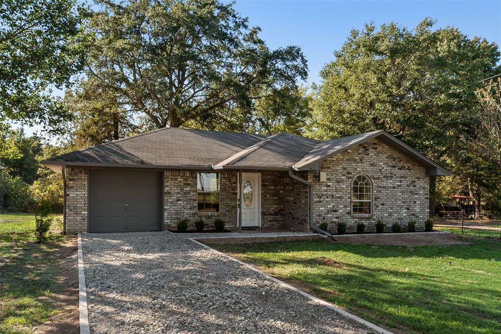 751 County Road 1240 Mount Pleasant, TX 75455 - Photo 1 of 35 a front view of a house with garden